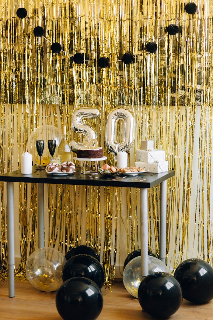 Mastering the First Impression: Your intriguing post title goes here A stylish setup for a 50th birthday party featuring golden decorations and a festive cake.